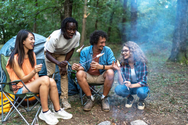 istock Young happy friends roasting marshmallows above campfire in nature 1751901954