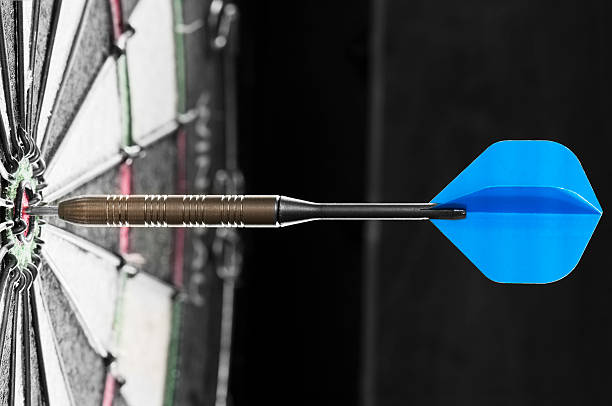 istock Single blue dart hits the bulls eye on dart board 175190314