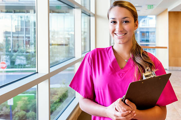 istock Young Hispanic Nurse in Pink Scrubs with Clipboard 175190522