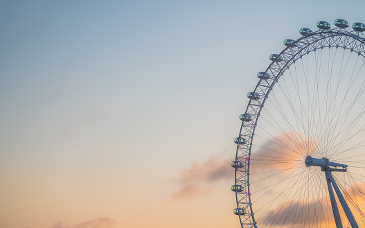 LONDON, ENGLAND - JUNE 19, 2023 The London Eye on the South Bank of the River Thames at sunrise in London, England.Copyspace banner. High quality photo