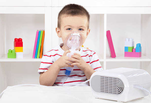 istock Little boy having inhalation at home 175190621