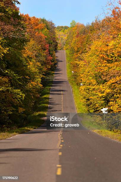 Fall Colors On A Rural Roadway In Michigan Stock Photo - Download Image Now - Autumn, Country Road, Hill