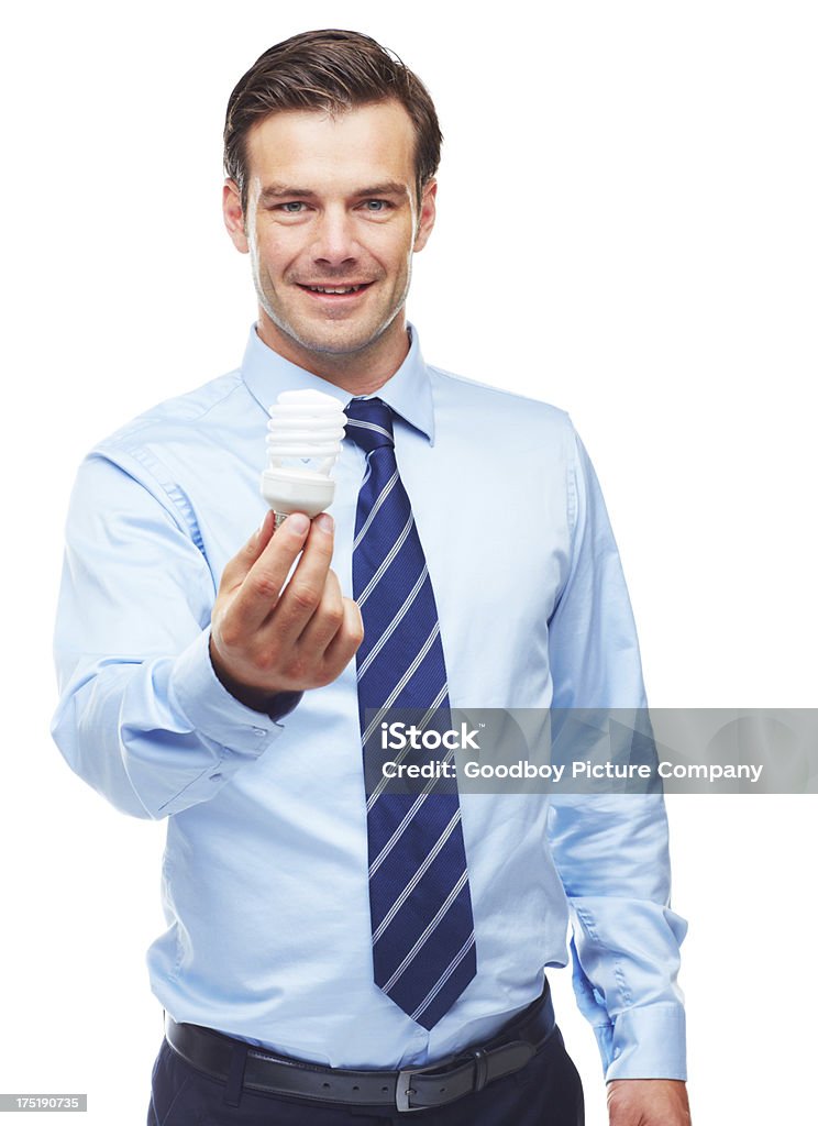 Holding the future of energy efficient business Business executive holding a energy saver light bulb Adult Stock Photo