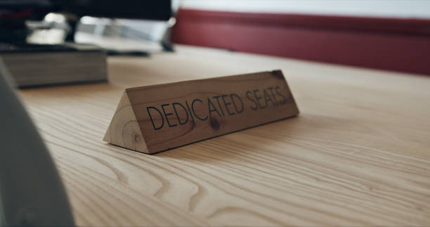 istock Education, desk and classroom with sign for dedicated seat in a university for examination closeup. School, college and table with information on campus for academic skill development or training 1751908684