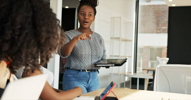 istock Black woman, speaker and presentation, tablet in meeting for workshop at creative startup with planning. Business people, team discussion or seminar, strategy and communication with digital tech 1751909518