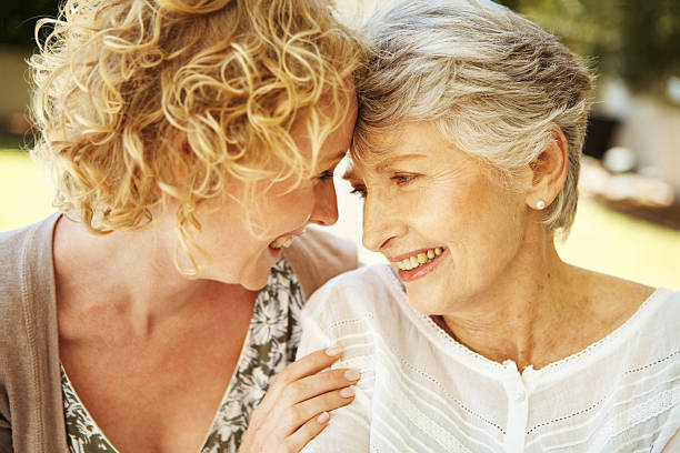 istock Mother and daughter smiling at each other outside 175190968