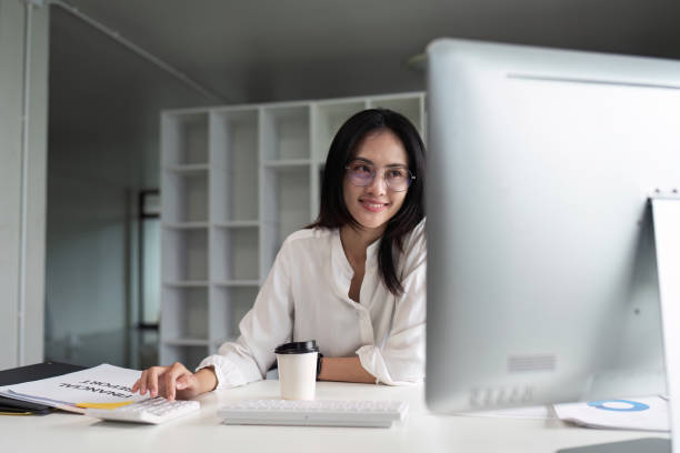 istock businesswoman accountant using calculator and computer for matching financial data saving in office room 1751913081