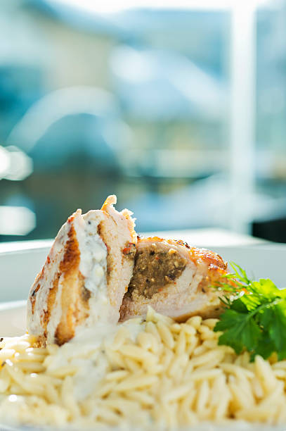Chicken and pasta "Stuffed chicken with eggplant and mushrooms on pasta, shallow doff" cooked selective focus vertical pasta stock pictures, royalty-free photos & images