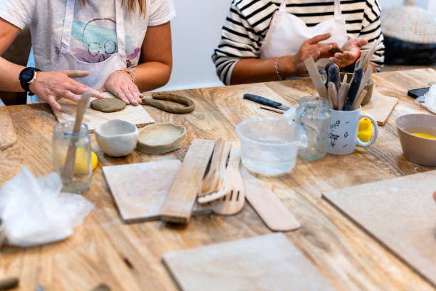 istock Ceramic Workshop. Closeup of a young woman's hands working clay 1751923130