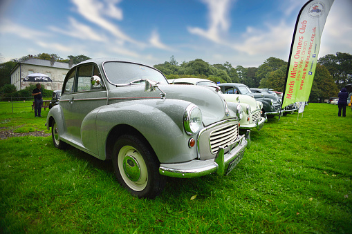 Felixstowe, Suffolk, England - August 21, 2019: Classic Green MG parked on coastal road with the ocean in the background.