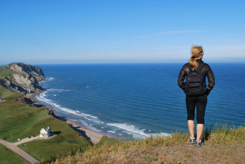 A young woman hiking in Magdalen Islands. The Magdalen Islands (les de la Madeleine) form a small archipelago in the Gulf of Saint Lawrence and form part of the Canadian province of Quebec.