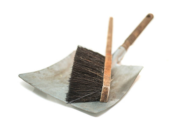 Woman with green feather duster for spring cleaning 
