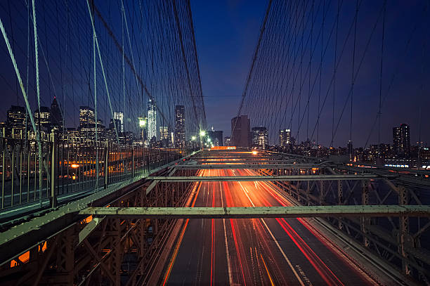 istock Traffic on Brooklyn Bridge against New York skyline by night 175193647