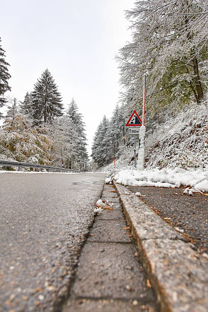 istock winter road with warning sign and bad weather 175193668