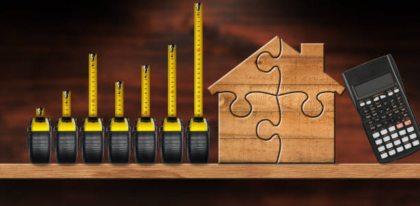 istock Tape Measures Forming a Bar Graph and a Wooden House 1751936878