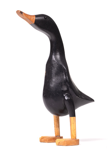 Funny wooden black duck on a white background