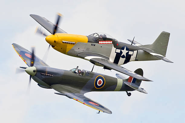 Classic Fighters of Word War Two A RAF Spitfire Mk IXB and a USAF P51D Mustang classic fighter aircraft of world War two. This photograph taken on a training exercise at Old Buckenham in the United KingdomTo see my other aviation images please click the image below p51 mustang stock pictures, royalty-free photos & images