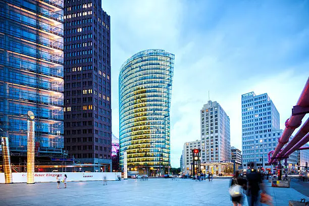 "illuminated Business towers in the eveningmotion blurred people movingPotsdamer Platz, Berlin, Germany"