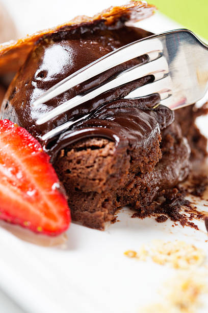 istock Digging into delicious dessert of warm chocolate fondant with fork 175194787