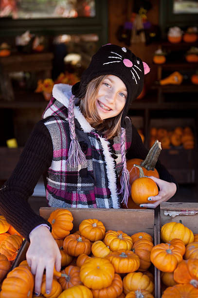 istock Young Girl Choosing Halloween Gourds 175194915