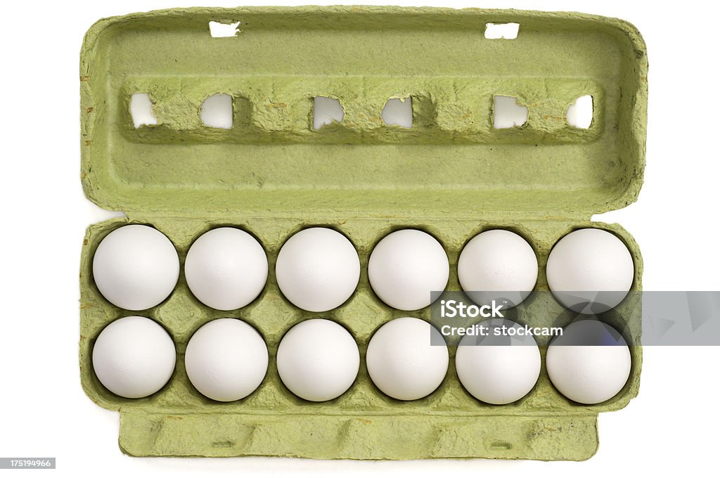 Eggs in a carton on white background "White eggs in a cardboard tray, isolated on white." Abundance Stock Photo