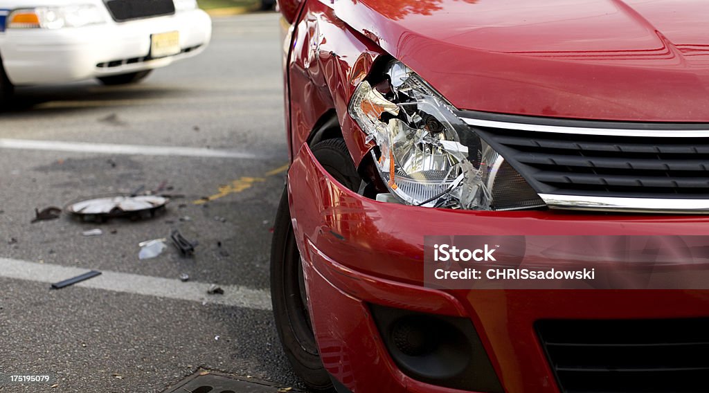 A red car with a damaged headlight after an accident Red Car in an Accident. Image Detail with Selective Focus. Car Accident Stock Photo