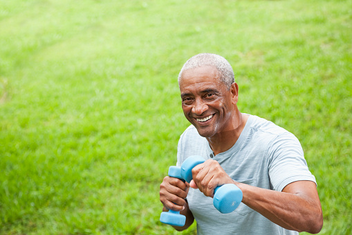 African American senior man (60s) exercising outdoors.