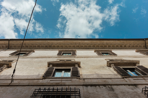frogs perspective view of typical Italian building, blue sky