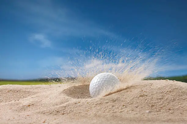 Photo of golf ball in sand trap