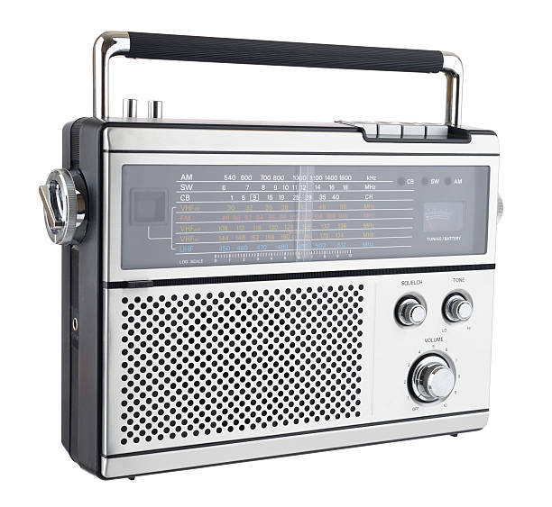 1970s Radio "An old, multi-band, portable radio from the 1970s shot in the studio and isolated on a white background." vintage portable silver radio stock pictures, royalty-free photos & images
