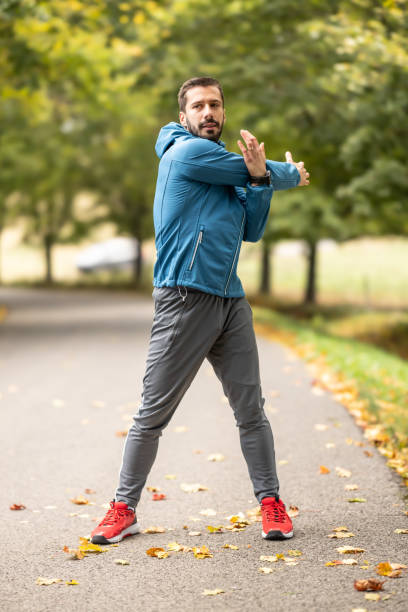 istock A young athlete is warming up before running training in the park. 1751980513