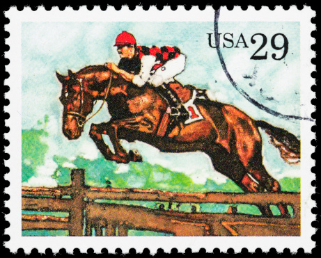 A USA postage stamp with an illustration of a racehorse jumping a hurdle in a steeplechase.
