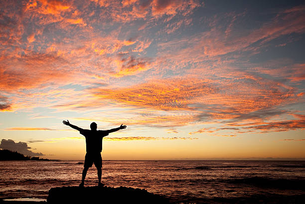 istock Man Lifting His Hands in Worship by the Sea 175198523