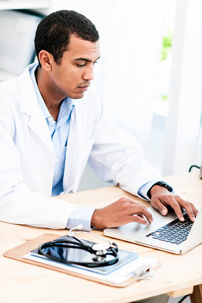 istock Doctor working at desk on laptop 175198606