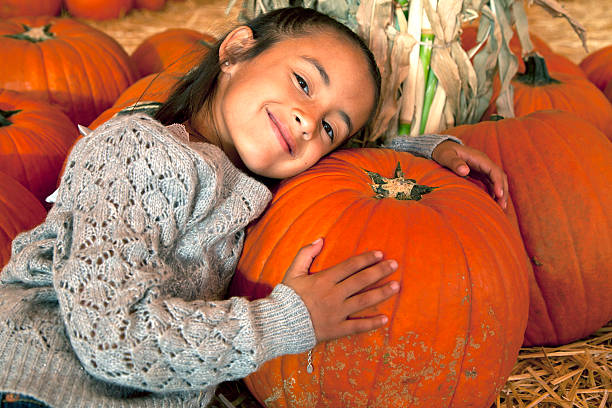 istock Little Girl with a Halloween Pumpkin 175198863