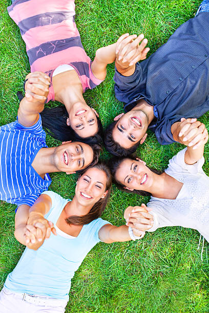 istock Group of young people lying in a circle 175199352