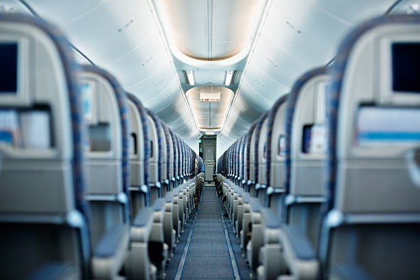 Empty seats Row of empty airplane seats. Shallow DOF. airplane interior stock pictures, royalty-free photos & images