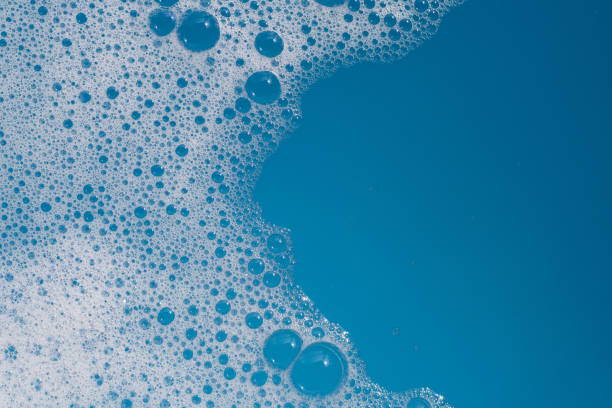 istock Detergent foam bubble on water. Blue background, Soap sud 1752000302