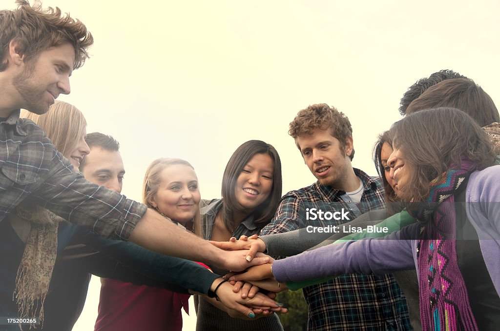 Multi-Ethnic Group of Students Unity group of people hands clasped 20-24 Years Stock Photo