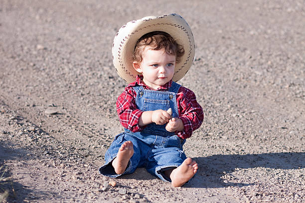 istock Little Boy Outdoors in Blue Denim Overalls and Cowboy Hat 175201213