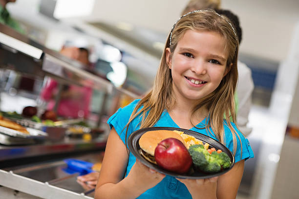 istock Happy elementary student with healthy lunch in school cafeteria 175201340