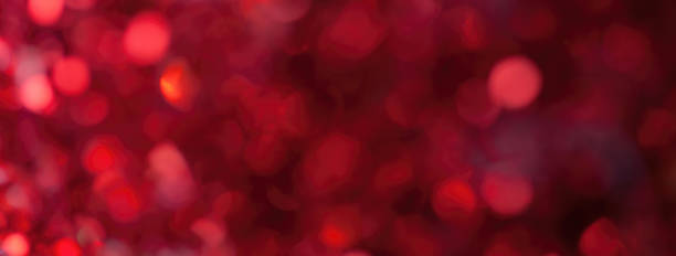 istock Blurred dark red sparkling background from sequins, macro. Shiny wine glittery bokeh of christmas garland. 1752014135