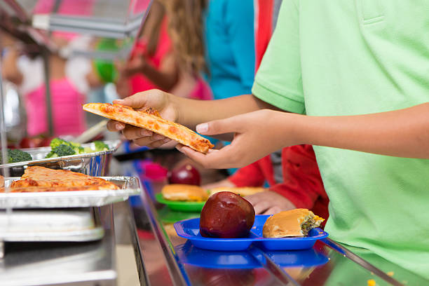 istock Elementary students choosing healthy/unhealthy food in school cafeteria line 175201558