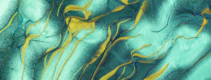 Abstract fluid art background cyan and golden colors. Liquid marble. Acrylic painting on canvas with yellow lines and cerulean gradient. Backdrop with teal waves pattern.