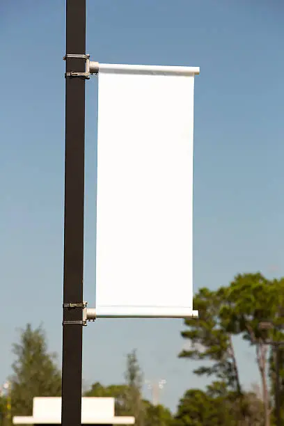 Photo of White vertical Banner against a Blue Sky