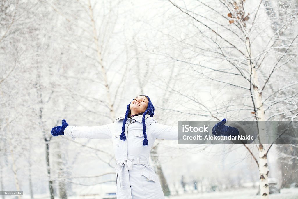 Winter joy Young and beautiful smiling woman enjoying the snow Adult Stock Photo