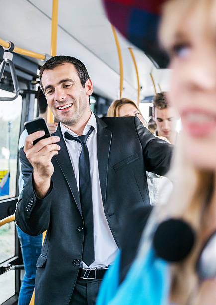istock Mid adult man sending text messages while commuting by bus. 175203729