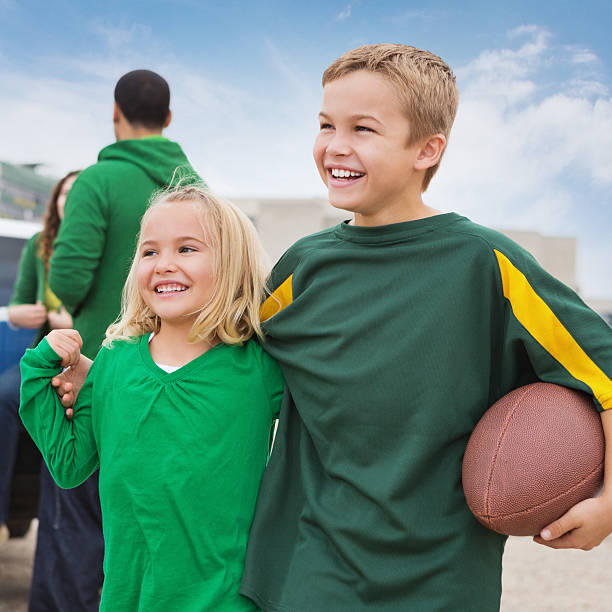 Excited kids at football stadium, tailgating with family "Excited kids at football stadium, tailgating with family" people family tailgate party outdoors stock pictures, royalty-free photos & images