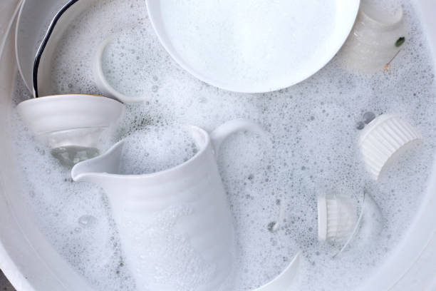 istock Dishes and bowls in water and bubbles of dishwashing liquid. Kitchen work 1752043576