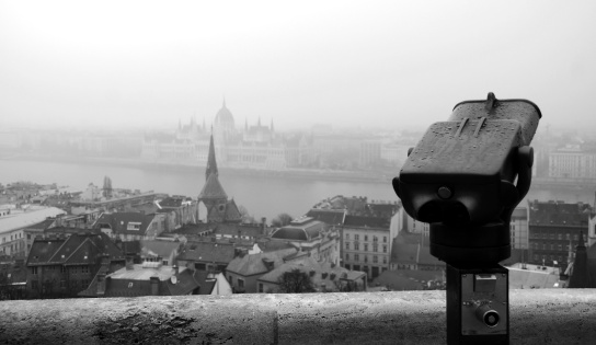 Pay Tourist Telescope Viewfinder in Focus with Budapest Parliament Building and the Danube in Background. Shot on Christmas Eve 2011 in the rain from Buda Castle.